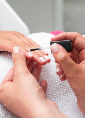 high-angle-woman-doing-manicure-client